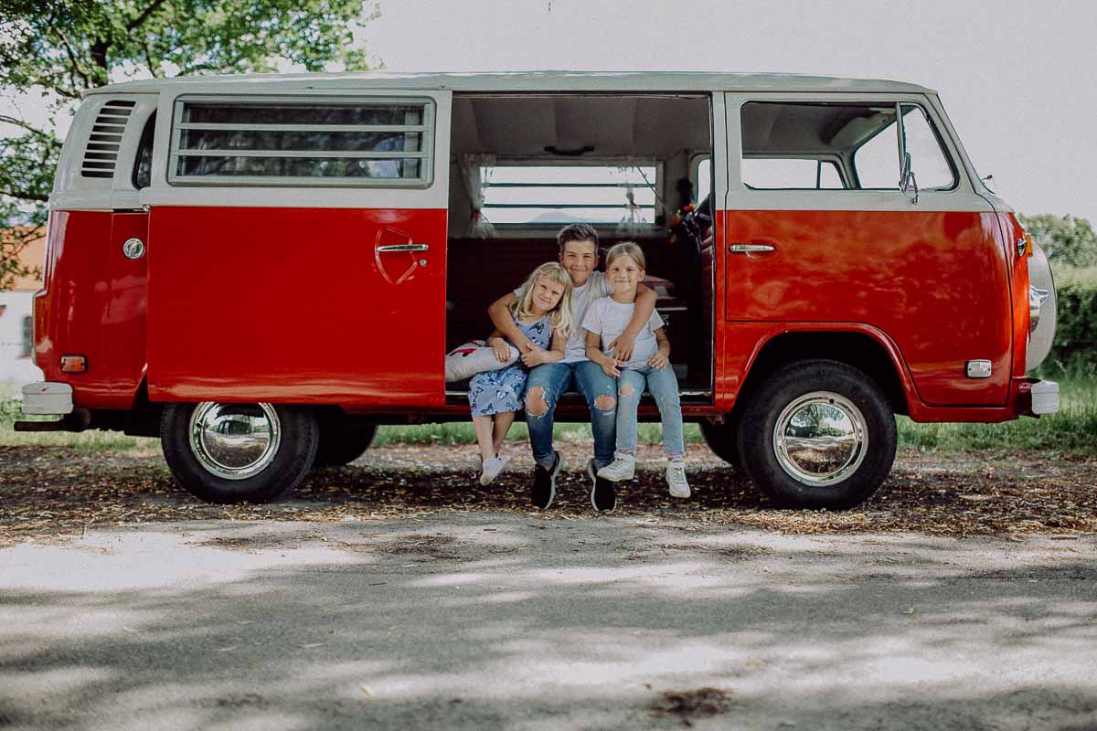 Kinder im geöffneten roten VW-Bulli